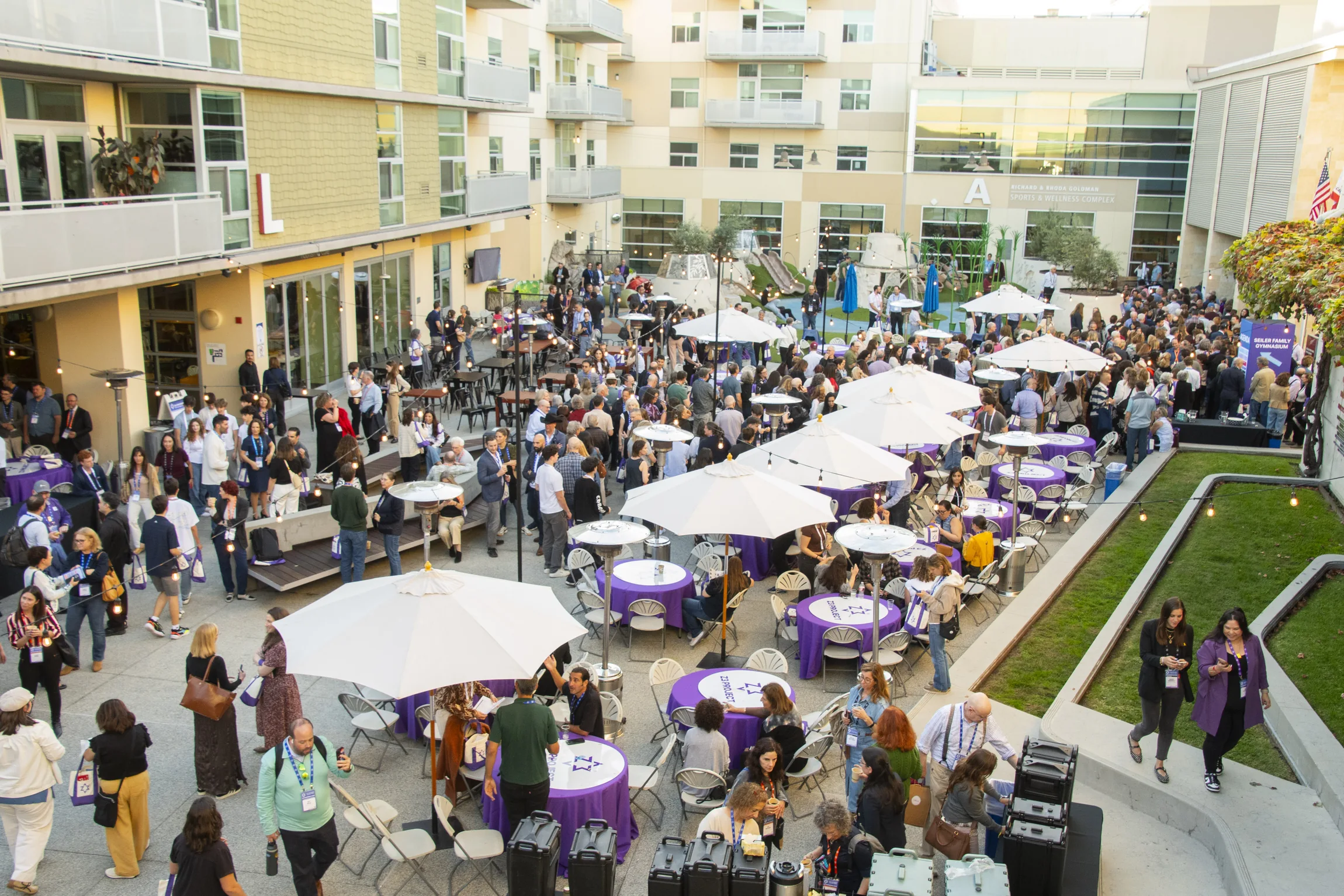 People gathering and talking throughout the Z3 Conference courtyard at the Oshman Family JCC